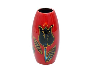 A shiny bright red vase with a hand painted black tulip outlined with gold, on the front and back of the vase.